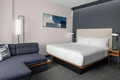 a hotel room with a bed and a couch at Courtyard by Marriott Calgary Downtown in Calgary