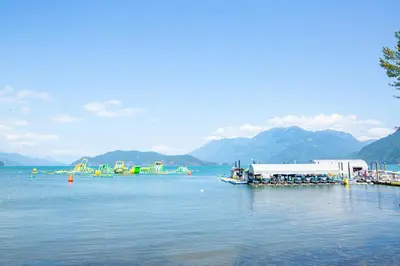 a lake with a group of boats in the water at Harrison On The Lake, Walkable to Beach and Village in Harrison Hot Springs