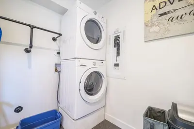 a laundry room with a washer and dryer at Storm Bay, Family Home with Hot Tub and Inlet View in Ucluelet