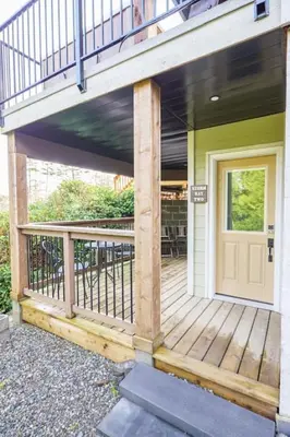 a front porch of a house with a deck at Storm Bay, Modern 1 Bed Suite and Chefs Kitchen in Ucluelet