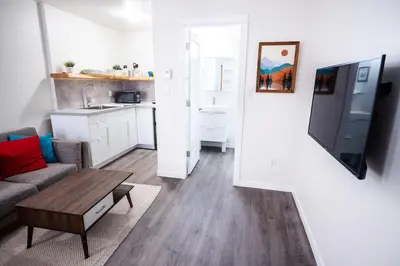 a small living room with a couch and a table at Kingfisher, Newly Renovated Suite on Ocean Inlet in Ucluelet