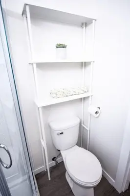 a small bathroom with a toilet and a shower at Kingfisher, Newly Renovated Suite on Ocean Inlet in Ucluelet