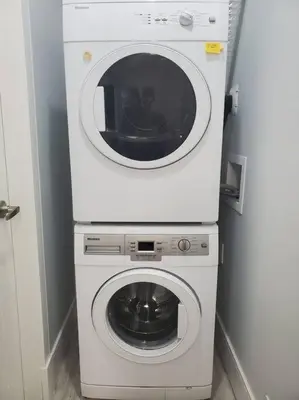 a white washer and dryer in a room at Cozy Guest Suite in Quiet Home with Private Entry in Vancouver