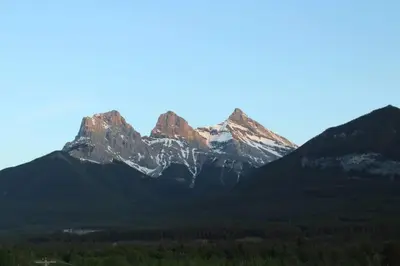 a group of mountains with trees in front of them at Spacious Penthouse Suite-King Beds-Pool & Hot Tub in Canmore