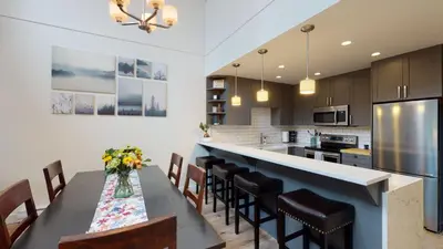 a kitchen with a table and chairs and a counter at Greyhawk by Whistler Premier in Whistler