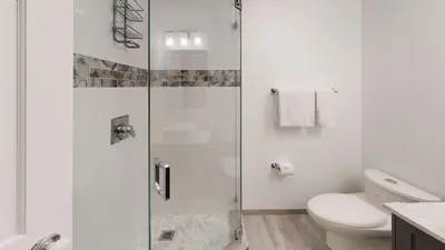 a bathroom with a glass shower with a toilet at Greyhawk by Whistler Premier in Whistler