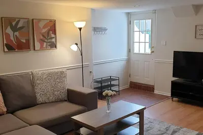 a living room with a couch and a table and a tv at Happy, Cozy, Loving Guest Space in West Vancouver in West Vancouver