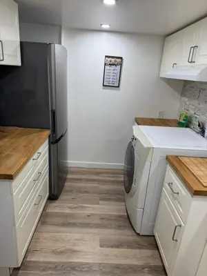 a kitchen with a refrigerator and a dishwasher at Happy, Cozy, Loving Guest Space in West Vancouver in West Vancouver