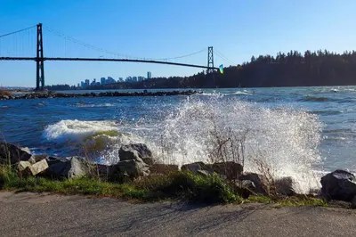 a body of water with a bridge in the background at Happy, Cozy, Loving Guest Space in West Vancouver in West Vancouver