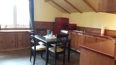 a kitchen with a table and chairs in a kitchen at Tschurtschenthaler Rentals in Golden
