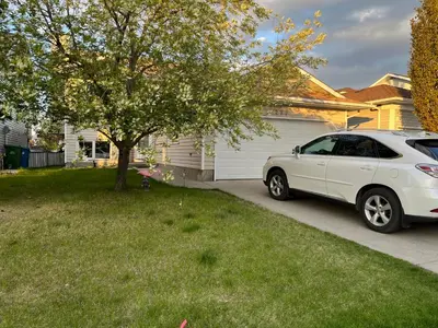 a white car parked in the driveway of a house at citadel hills valley in Calgary