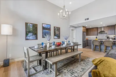 a dining room and living room with a table and chairs at BRAND NEW - Gorgeous Spring Creek Penthouse in Canmore