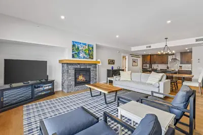a living room with a couch and a fireplace at Spring Creek Vacations in Canmore