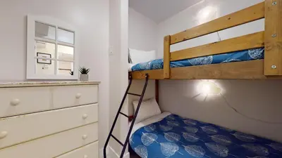 a bunk bed with a ladder in a bedroom at 1BR plus Den in Marketplace Lodge, Village Location, Mountain Views, Complex Hot Tub in Whistler
