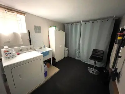 a small kitchen with a sink and a refrigerator at Suite Sunrise in Vancouver