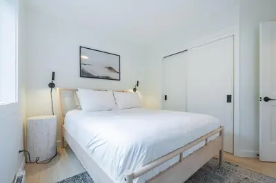 a bedroom with a large bed with white sheets at Powderview 24 by Outpost Whistler in Whistler