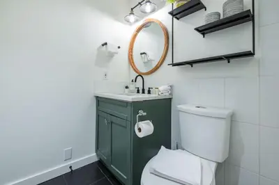 a bathroom with a green cabinet and a white toilet at Powderview 24 by Outpost Whistler in Whistler