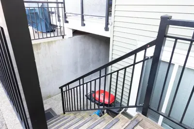 a stairway with a red ball sitting on top of it at Modern yet comfy 3 bed suite in Surrey in Surrey