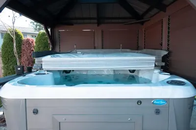 a large bath tub sitting in a backyard at Modern yet comfy 3 bed suite in Surrey in Surrey