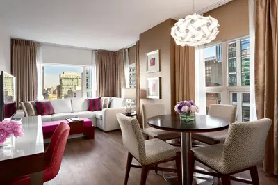a living room with a couch and a table with chairs at Auberge Vancouver Hotel in Vancouver