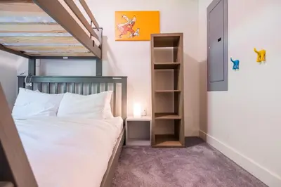 a bedroom with a bed and a book shelf at Ravencrest by Outpost Whistler in Whistler