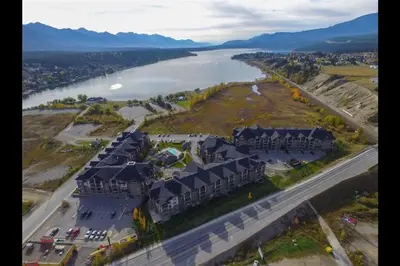 an aerial view of a house next to a river at Lookout Pointe, Lakeview, Pool, Hot Tub, Gym in Invermere