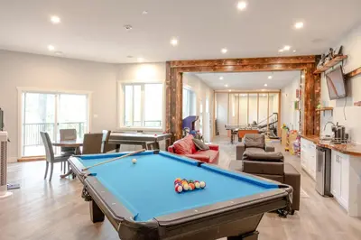 a living room with a pool table in it at Ski in Ski Out with Huge Game Room and Hot Tub in Fernie