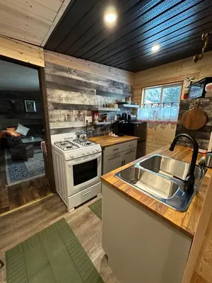 a kitchen with a stove and a sink at The Cabin in Stewart