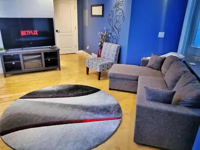 a living room with a couch and a tv at LuxQuarters Kitimat River Suite in Kitimat