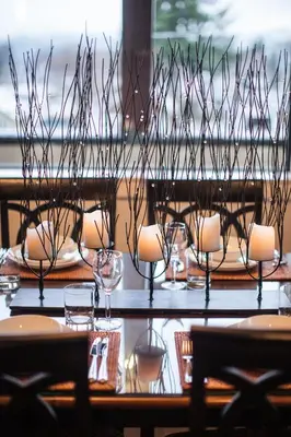a table with chairs and wine glasses on it at Alpenglow Penthouse by Revelstoke Vacations in Revelstoke