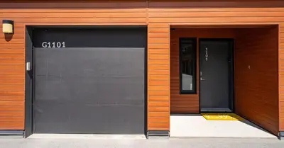 two garage doors in a building with a sign on it at RendezView by Revelstoke Vacations in Revelstoke