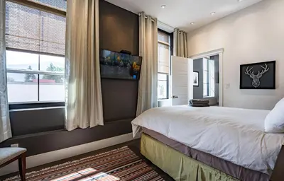 a bedroom with a bed and a large window at In the Heart of it All by Revelstoke Vacations in Revelstoke