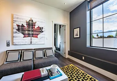 a living room with a couch and a window at In the Heart of it All by Revelstoke Vacations in Revelstoke