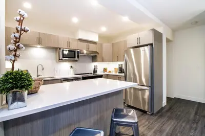 a kitchen with a stainless steel refrigerator at Revelstoke Retreat by Revelstoke Vacations in Revelstoke