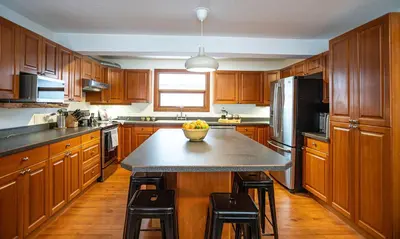 a kitchen with a island with a bowl of fruit on it at Mackenzie House by Revelstoke Vacations in Revelstoke