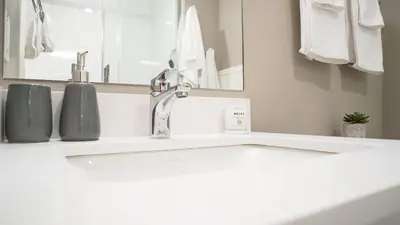 a bathroom with a white sink and a mirror at The Revy Den by Revelstoke Vacations in Revelstoke