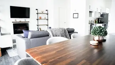 a living room with a wooden table and a couch at The Revy Den by Revelstoke Vacations in Revelstoke