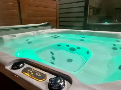 a jacuzzi tub in a bathroom with a blue at The Mac Shack by Revelstoke Vacations in Revelstoke