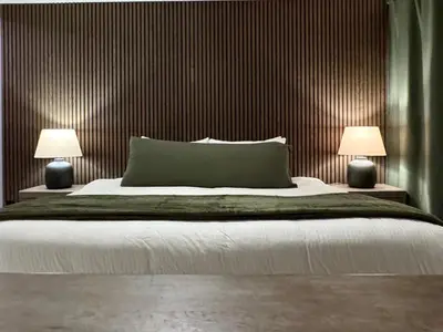 a bedroom with a large bed with two lamps at Granite Ridge Condo by Revelstoke Vacations in Revelstoke