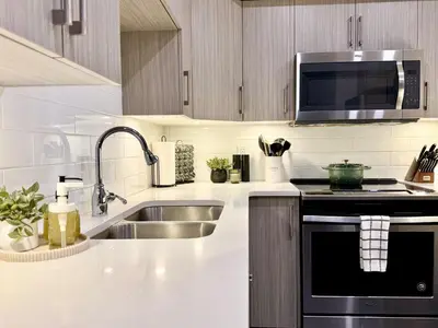 a kitchen with a sink and a microwave at Granite Ridge Condo by Revelstoke Vacations in Revelstoke