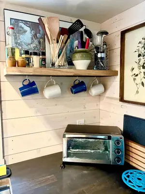a toaster oven sitting on the floor in a kitchen at Forest Nook in Queens Bay