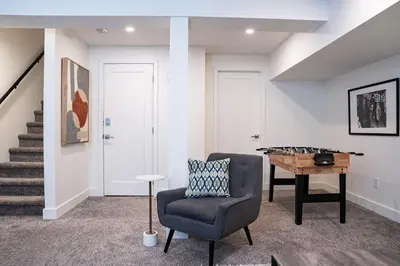 a living room with a chair and a table at Revelation Retreat by Revelstoke Vacations in Revelstoke