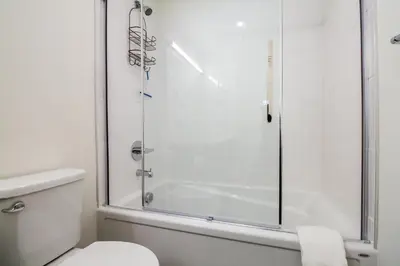 a bathroom with a shower and a toilet at Magog Condo by Revelstoke Vacations in Revelstoke