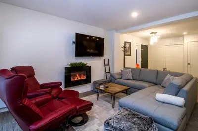 a living room with a couch and a fireplace at Magog Condo by Revelstoke Vacations in Revelstoke