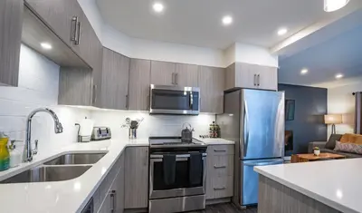 a kitchen with a sink and a refrigerator at Alpine Escape by Revelstoke Vacations in Revelstoke