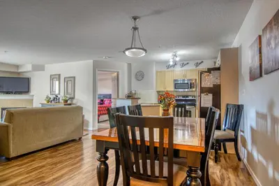 a dining room and kitchen with a table and chairs at Mountain getaway condo - 5 min walk to the beach! in Invermere