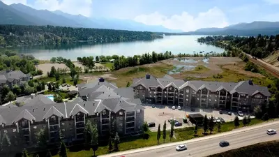 an aerial view of a resort with a lake at Mountain getaway condo - 5 min walk to the beach! in Invermere