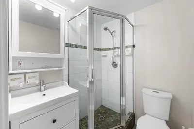 a bathroom with a shower and a toilet and a sink at Alpenglow Lodge Two Bedroom Apartment by MVA in Whistler