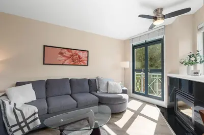 a living room with a couch and a fireplace at Alpenglow Lodge Two Bedroom Apartment by MVA in Whistler
