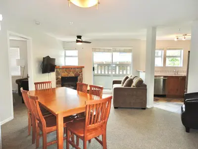 a dining room and living room with a table and chairs at Bear Lodge Two Bedroom by MVA in Whistler